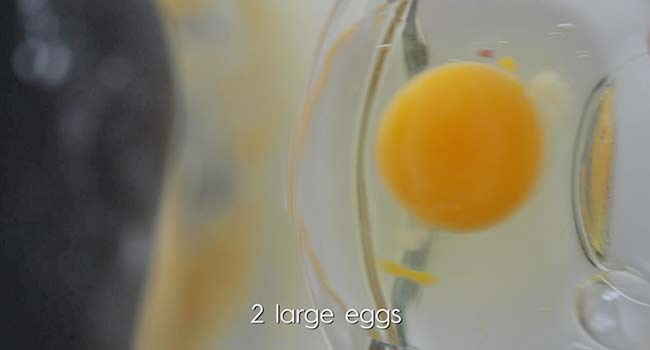 adding an egg to a stand mixer