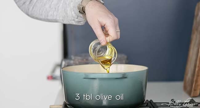 adding olive to a pot