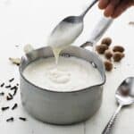 small size pot of white bechamel sauce with cloves and nutmeg