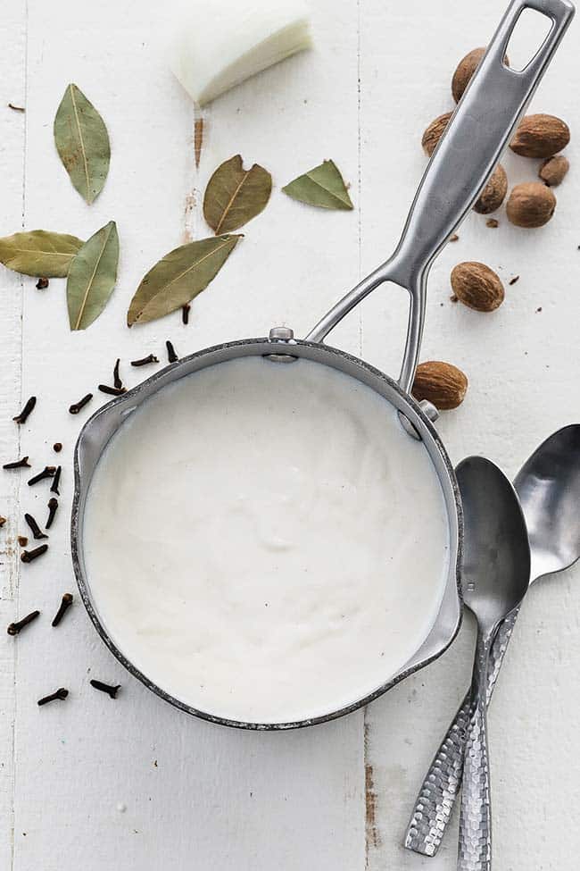 bechamel sauce in a pot with herbs and spices