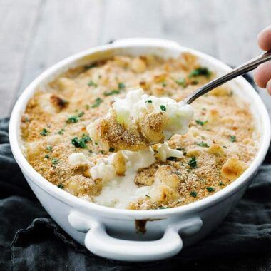 baking dish of cauliflower au gratin with a spoonful of it