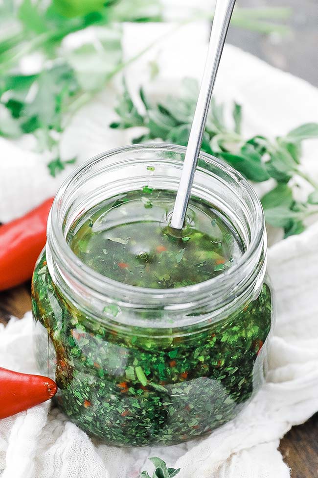 jar of chopped herbs and oil