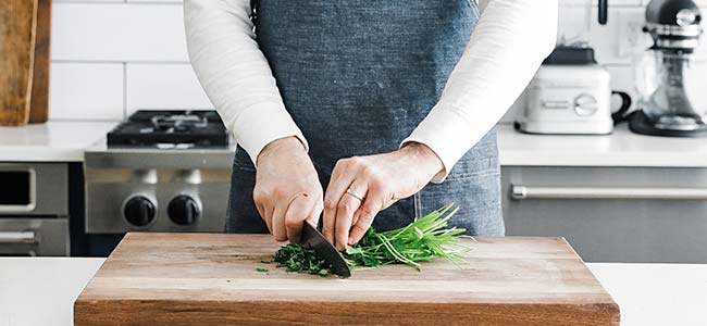 finely mincing parsley on a cutting board