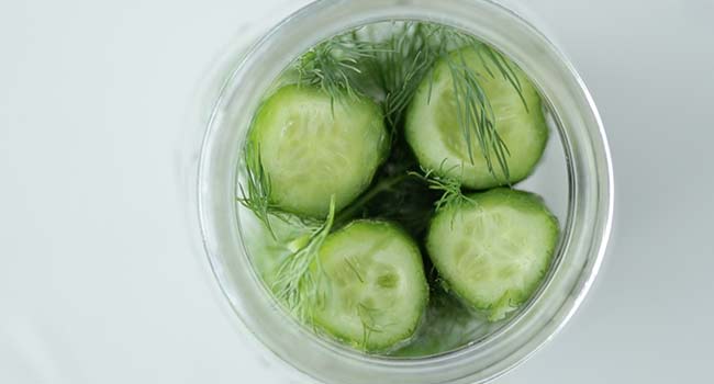 cucumbers in a jar with dill