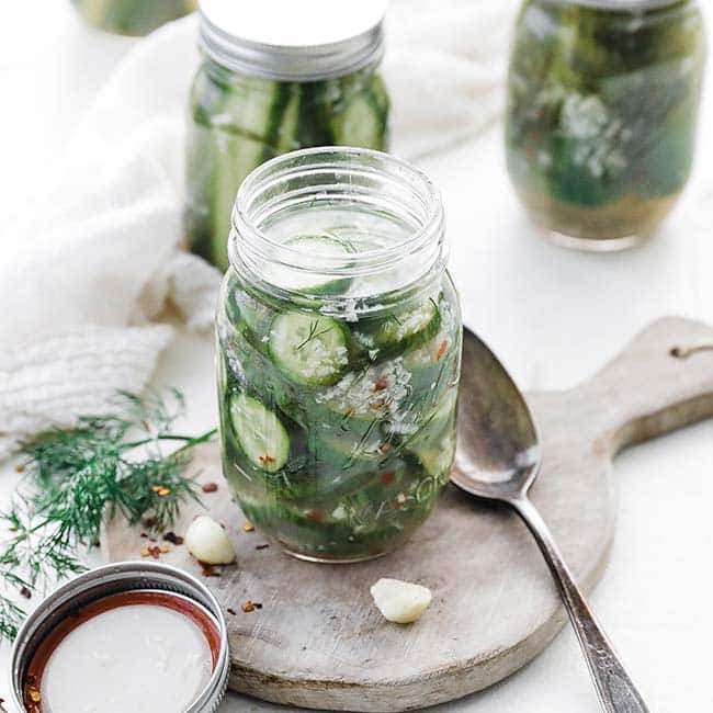 glass mason jar full of pickled cucumber chips