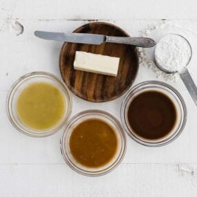 three bowls of different colored roux with butter and flour