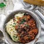 a bowl of fresh spaghetti and sauce with cheese and parsley