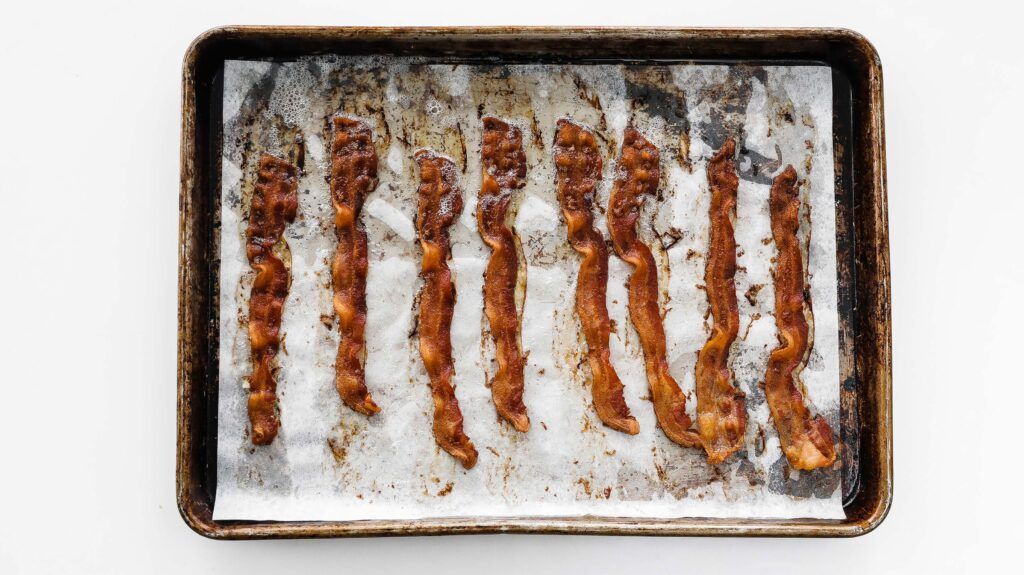 cooked crisp bacon on a sheet tray