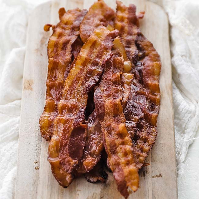 crisp cooked bacon on a cutting board