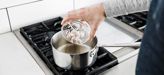 putting chopped shallots in a pot