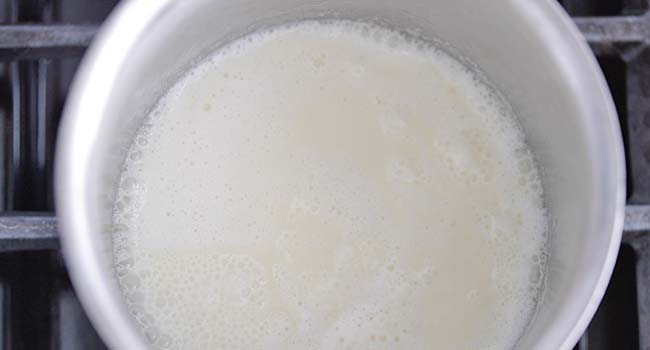 lightly boiling cream in a pot