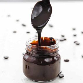 jar full of chocolate sauce with a spoon