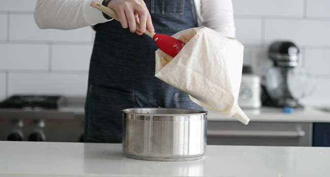 adding dough to a piping bag