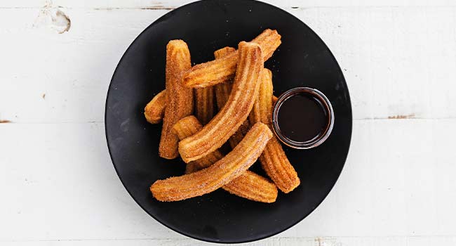 churros on a plate with chocolate sauce