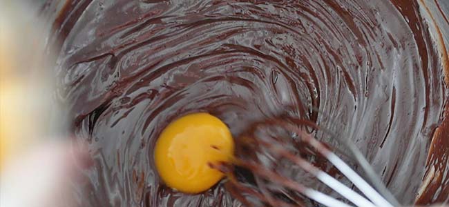 whisking eggs into melted chocolate