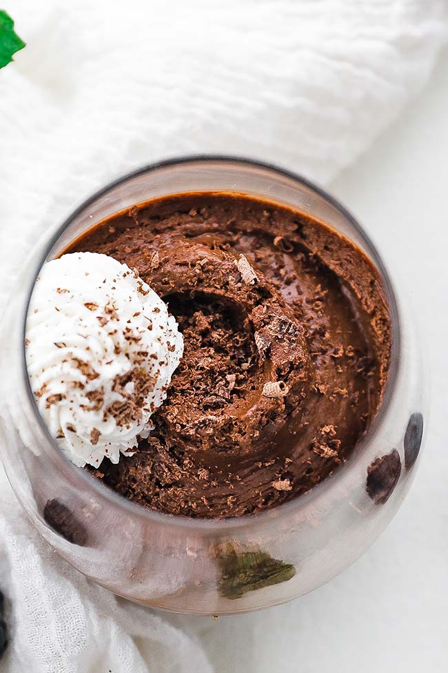 chocolate mousse with whipped cream and chocolate shavings