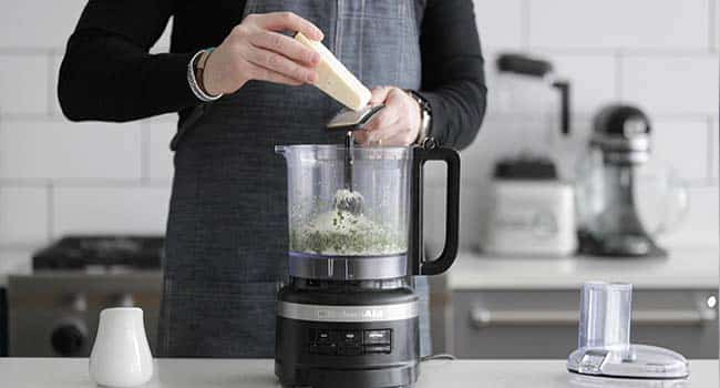 adding cheese to a food processor