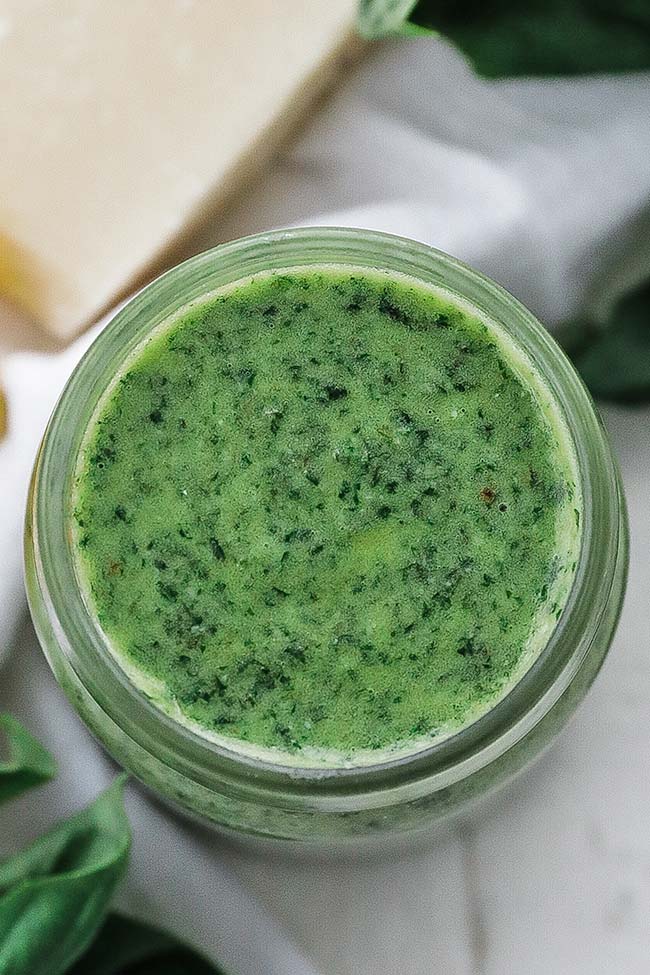 basil pesto sauce in a jar with cheese