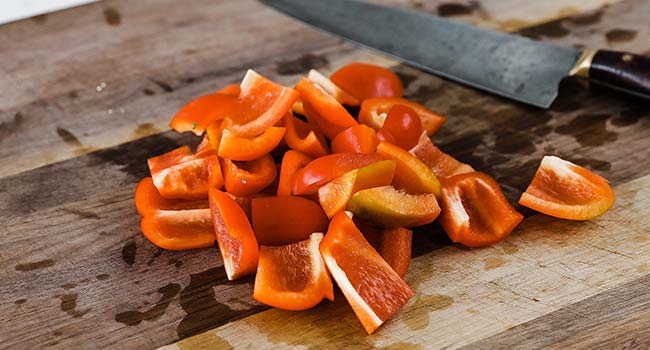 cut red peppers on a cutting board