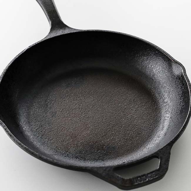 Hill & Holler - Dawn dish detergent and a heavy duty steel wool pad are my  personal favorites. Cast iron is really bad to hold on to oils and flavors  left from