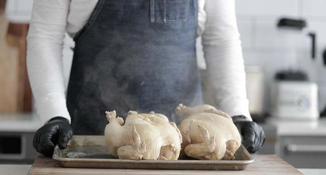 cooling cooked whole chickens on a tray