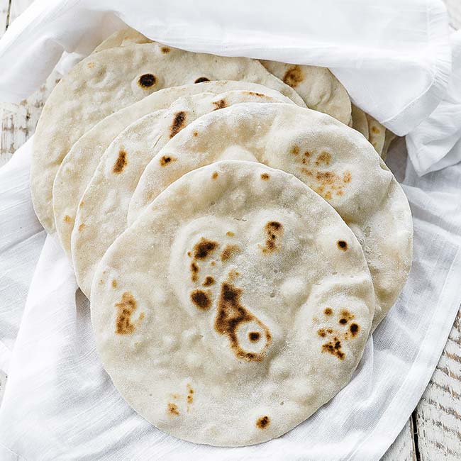 cooked flour tortillas in a cloth