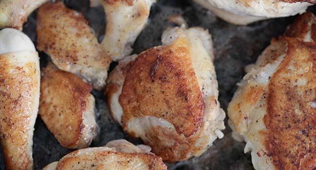 cooking chicken in a pan