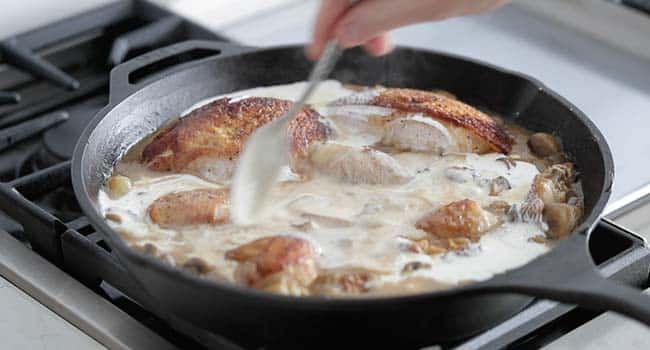 stirring cream into a chicken fricassee