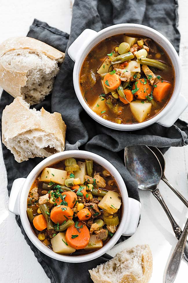 bowls of mulligan stew served alongside bread