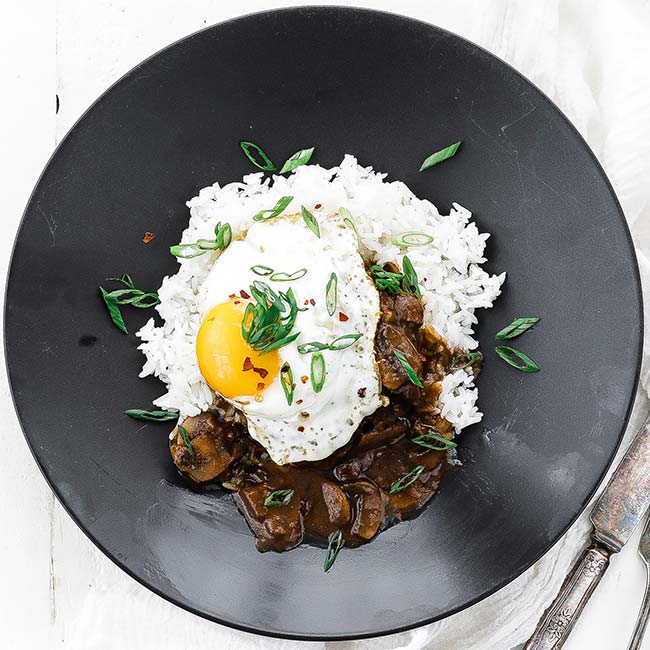 fried egg on top of a burger with white rice