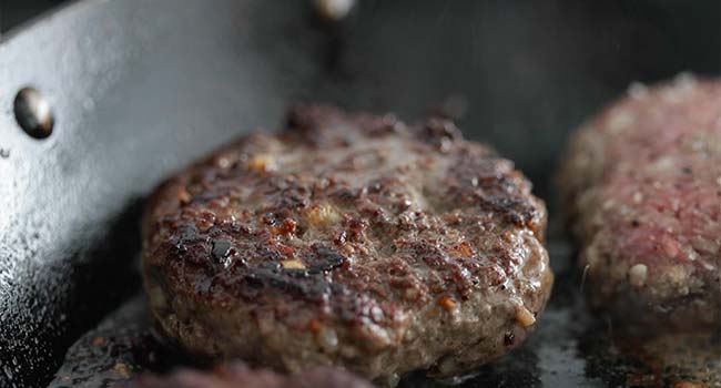 cooked burger patty in a pan