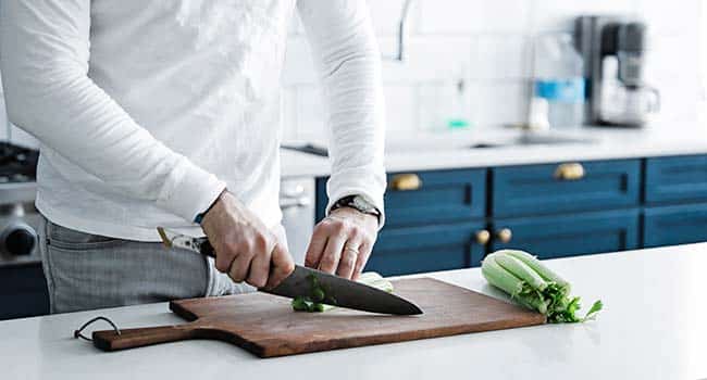 slicing vegetables on a cutting board