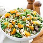 Mandarin orange salad in a bowl with herbs and chicken