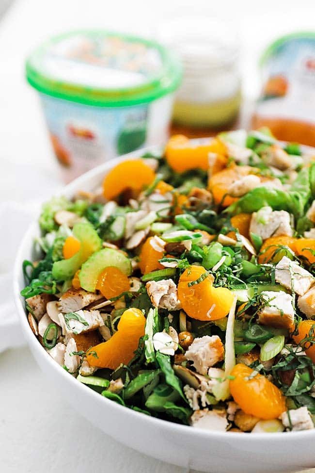 greens salad with almonds and chicken in a bowl