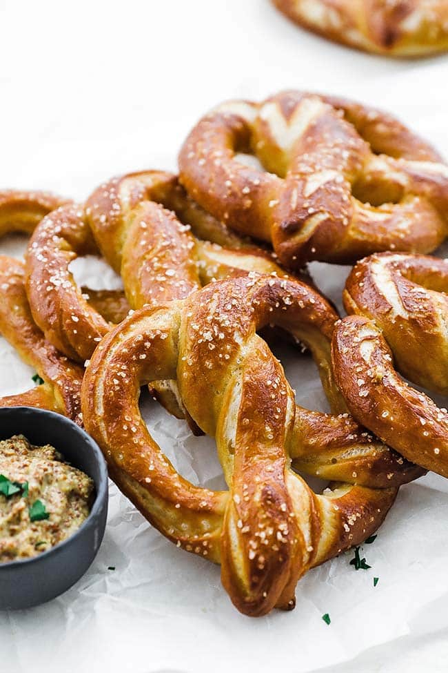 soft pretzel with salt on parchment paper