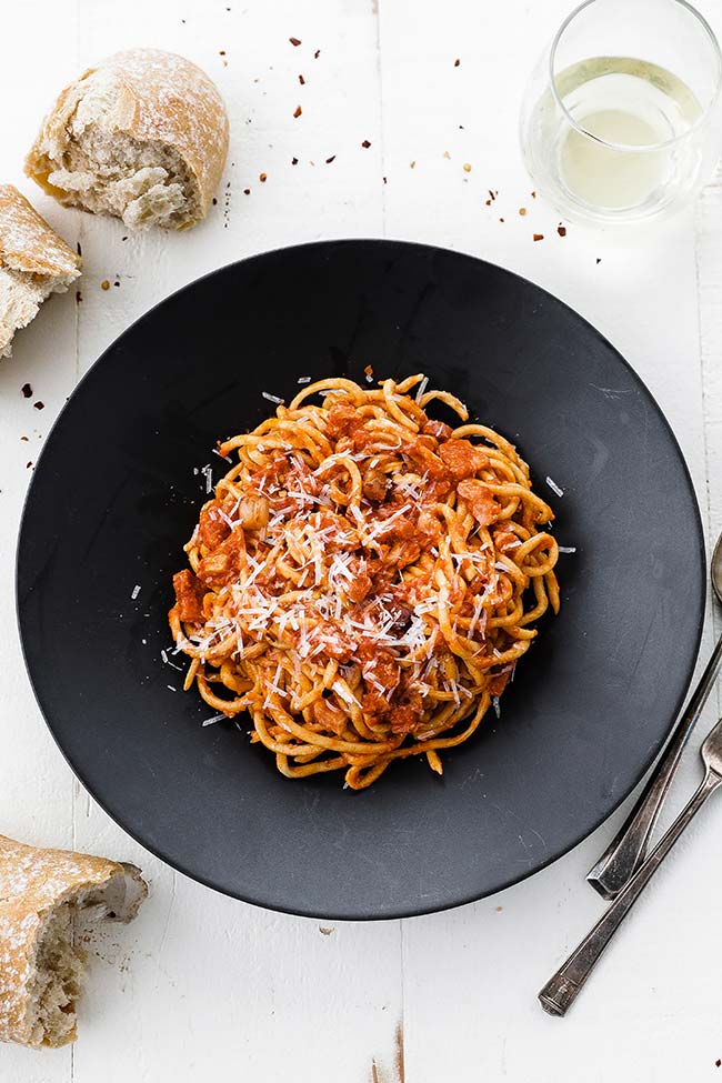 plate of Bucatini All’Amatriciana with wine