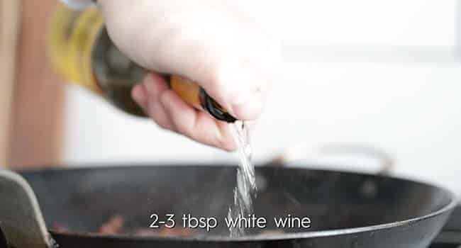 adding wine to deglaze in a pan