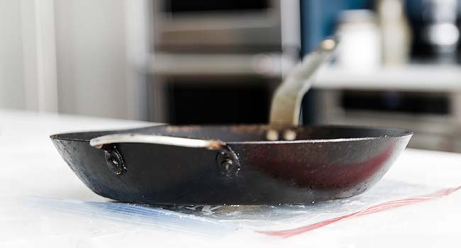 pressing dough down using a pan