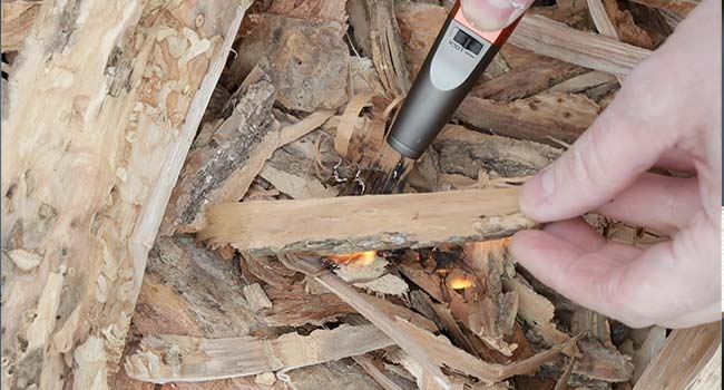 stacking kindling onto a fire