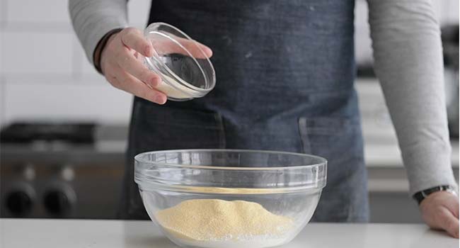 Adding dry ingredients to a large bowl