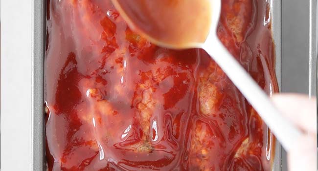 glazing the top of meatloaf with a tangy tomato sauce