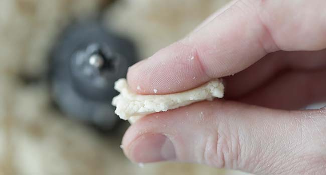 squeezing together raw dough