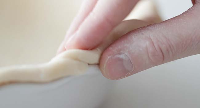 folding dough inwards to make a pie crust