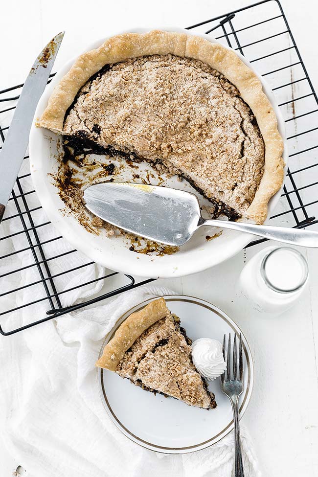 shoofly pie on a rack and a slice of pie on a plate with milk