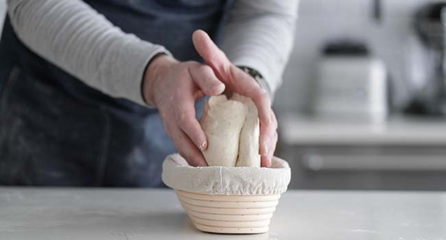 adding formed sourdough bread dough to a bannetton