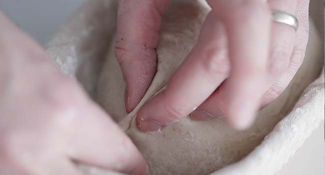 pinching together dough at the seams