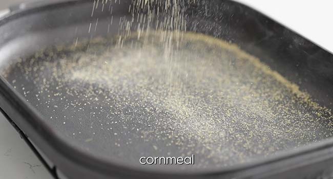 sprinkling cornmeal onto a hot preheated pan