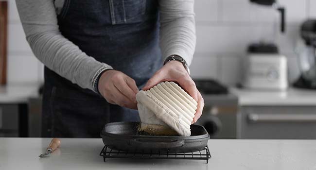 adding the bread dough to the hot pan