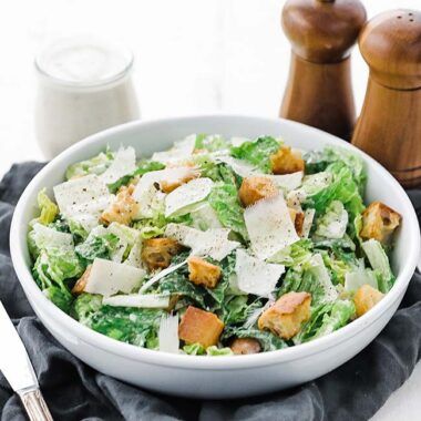 bowl of salad with salt and pepper shakers