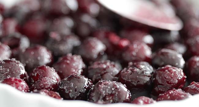 sugar coated fresh cherries in a tart pan